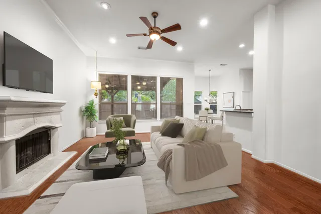 a living room with furniture fireplace and flat screen tv