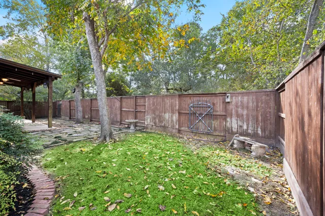 a view of backyard with small cabin and a chair