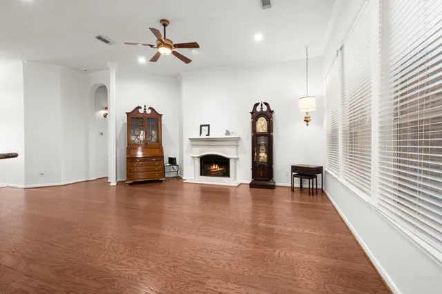 a view of an empty room with a fireplace and a window