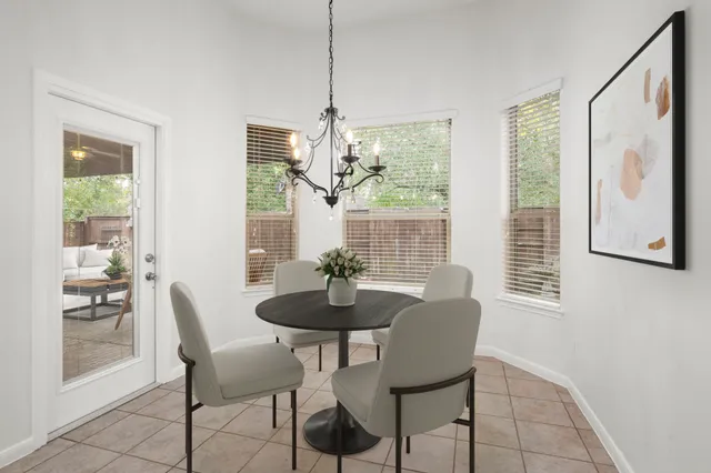 a dining room with furniture and window