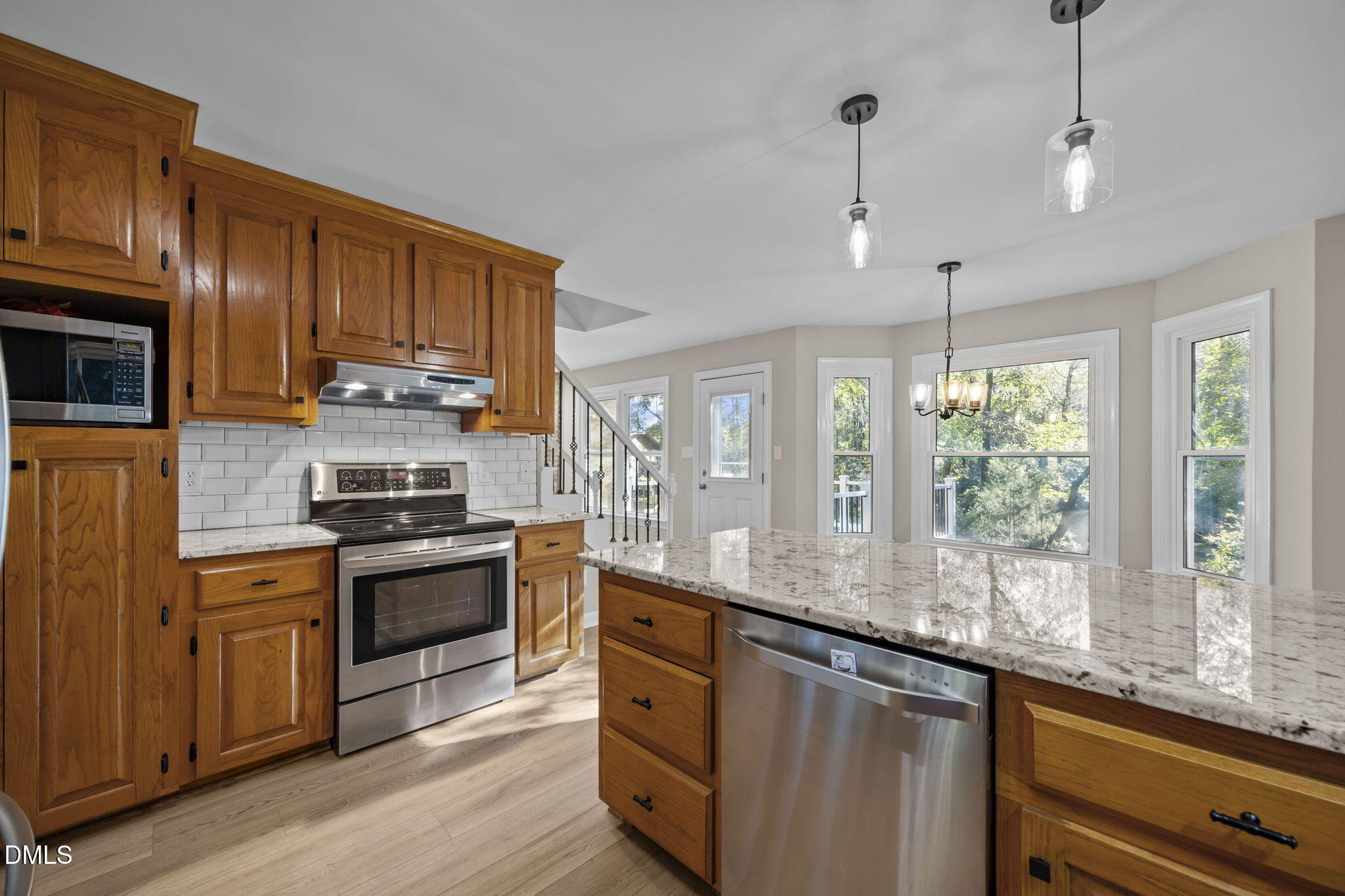 729 Wimberly Road Apex, NC 27523 - Photo 12 of 61 a kitchen with stainless steel appliances granite countertop a sink a stove and refrigerator