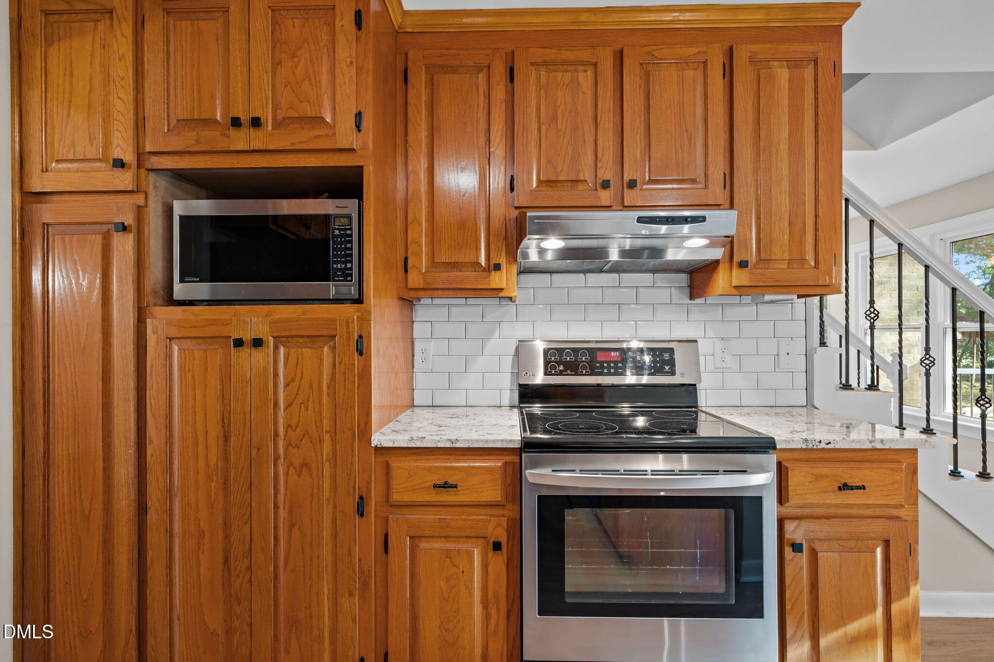 729 Wimberly Road Apex, NC 27523 - Photo 15 of 61 a kitchen with granite countertop wood cabinets stainless steel appliances and a sink