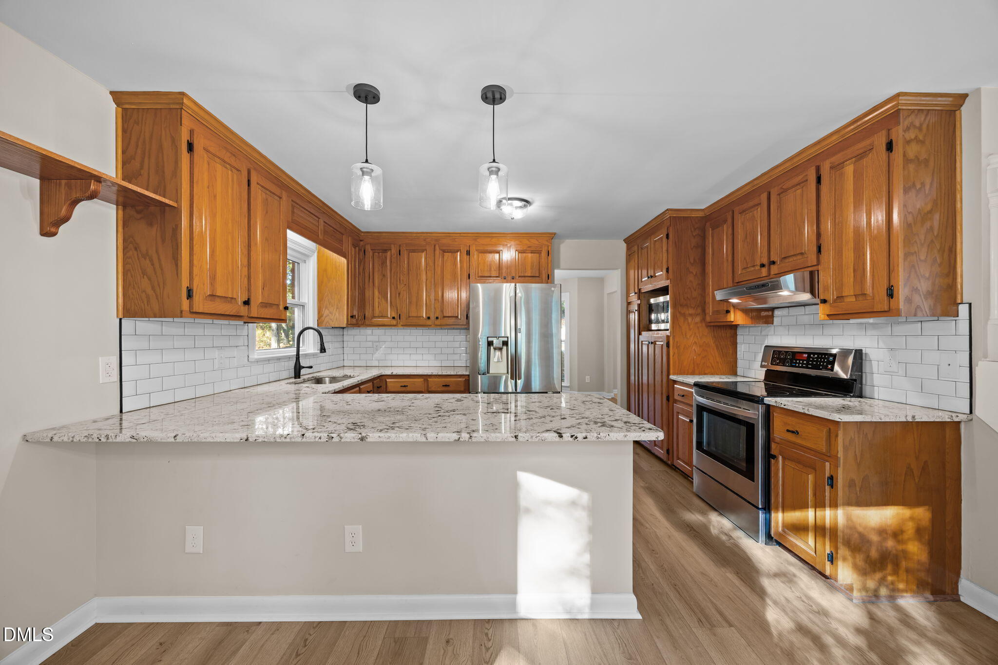 729 Wimberly Road Apex, NC 27523 - Photo 16 of 61 a kitchen with stainless steel appliances granite countertop a sink refrigerator and cabinets