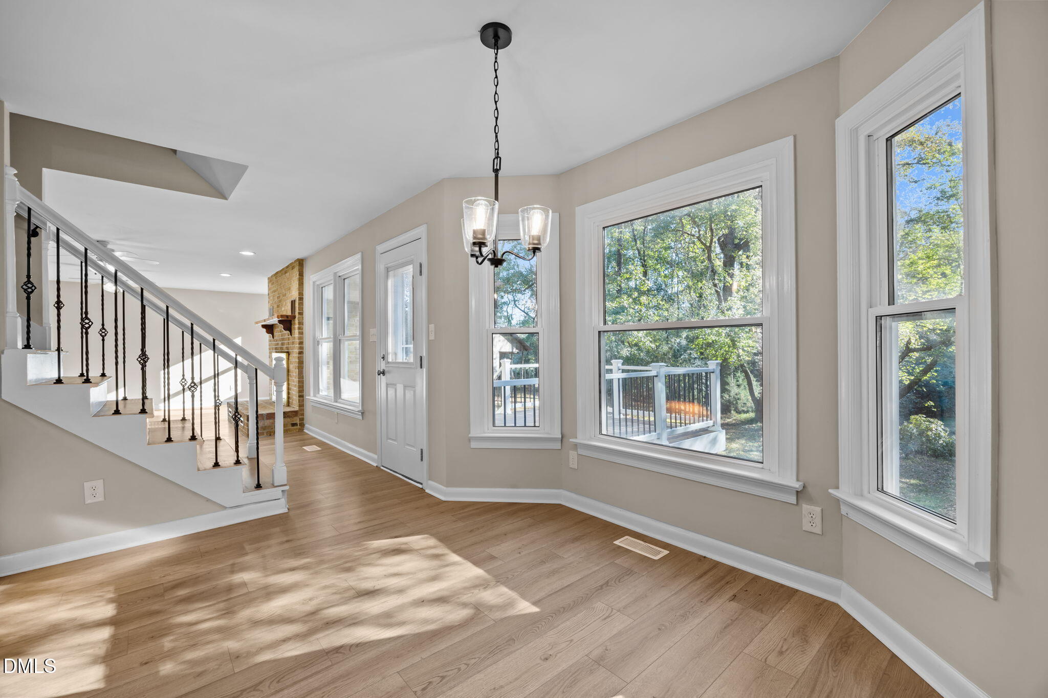 729 Wimberly Road Apex, NC 27523 - Photo 17 of 61 a view of an empty room with wooden floor and a window