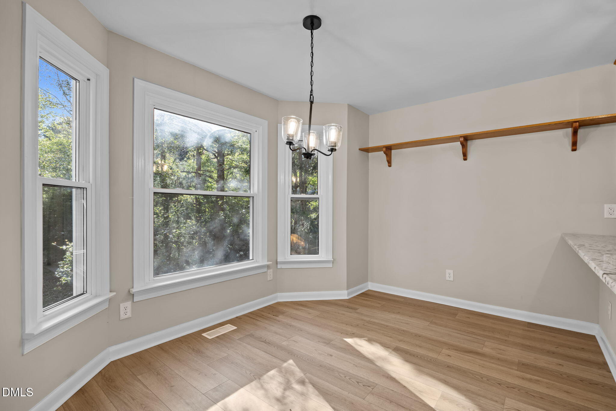729 Wimberly Road Apex, NC 27523 - Photo 18 of 61 a view of a room that has a window and wooden floor