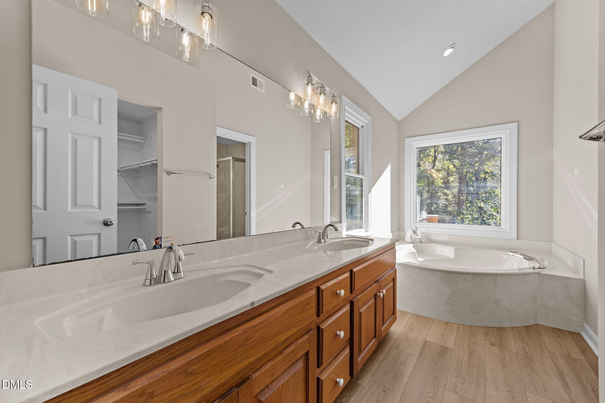 729 Wimberly Road Apex, NC 27523 - Photo 26 of 61 a bathroom with a tub double sink and mirror