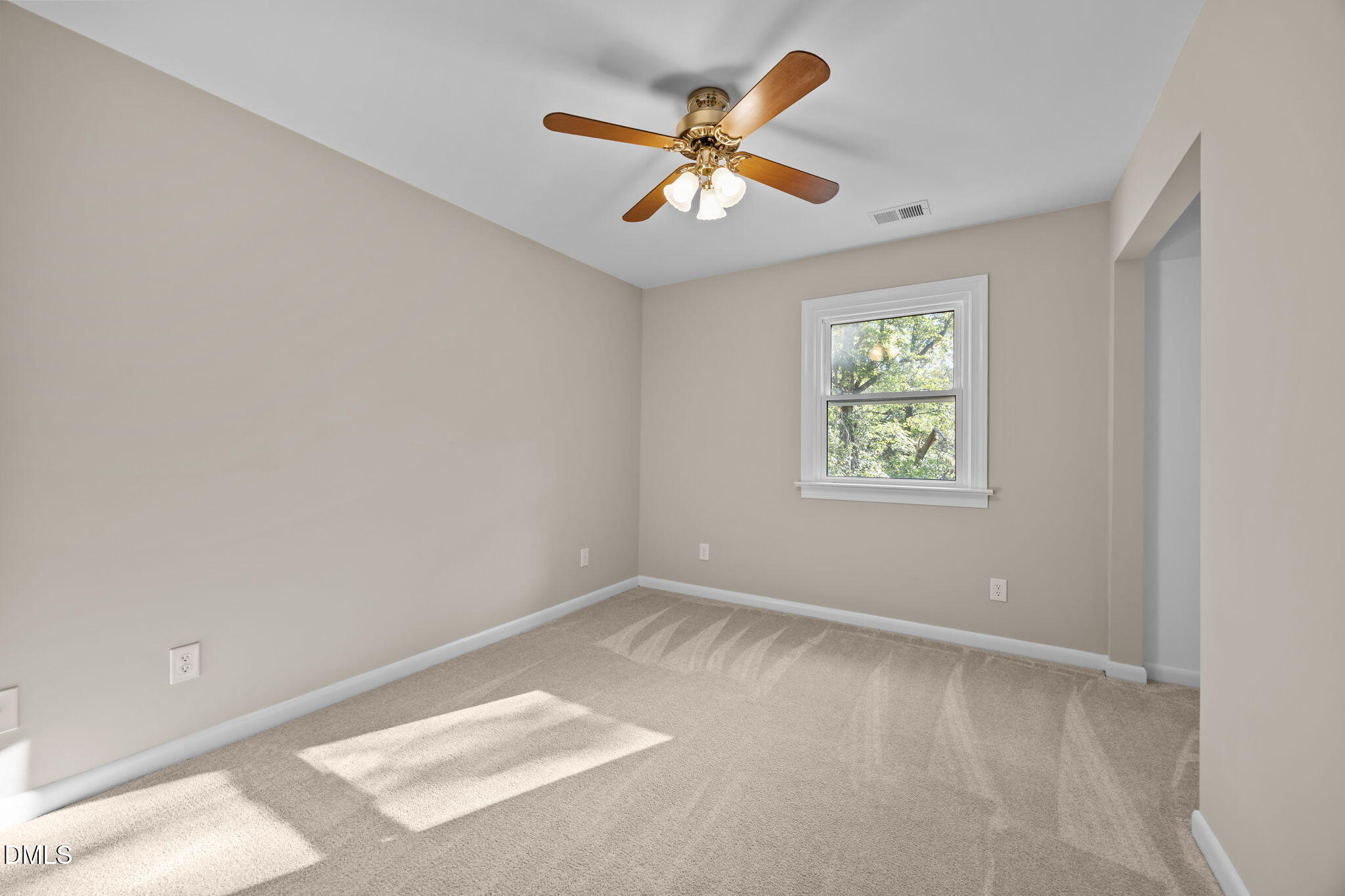 729 Wimberly Road Apex, NC 27523 - Photo 30 of 61 an empty room with a window and a ceiling fan