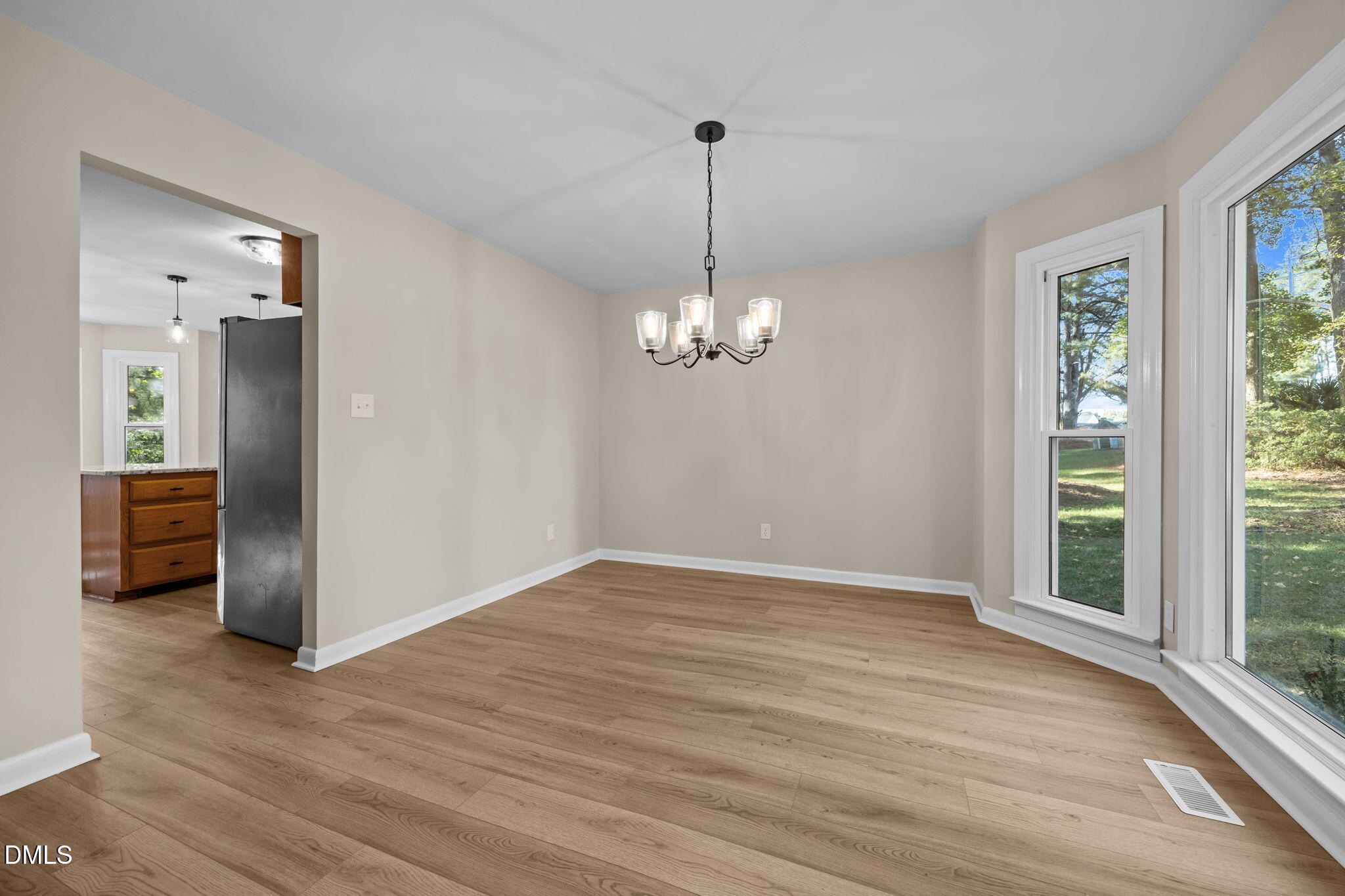 729 Wimberly Road Apex, NC 27523 - Photo 9 of 61 a view of a livingroom with a chandelier wooden floor and a chandelier