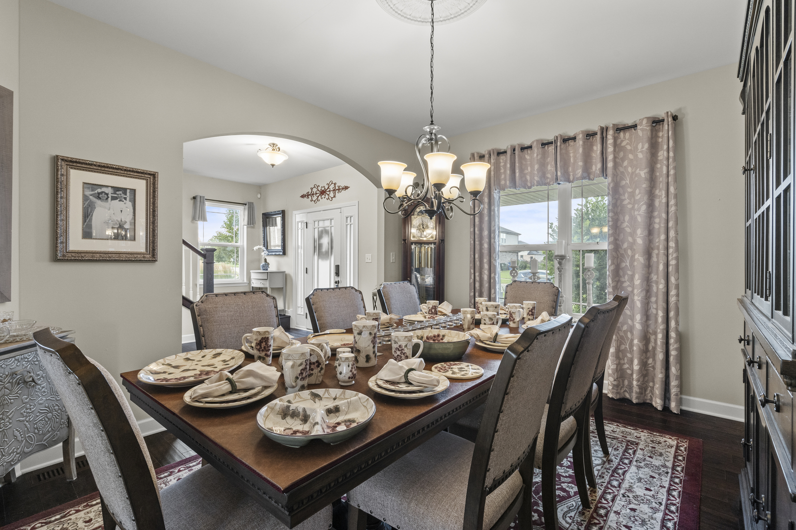 15711 Mueller Way Lockport, IL 60441 - Photo 11 of 37 a view of a dining room with furniture a chandelier and large windows