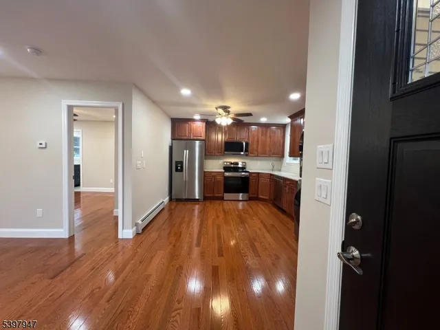 a view of a kitchen and wooden floor