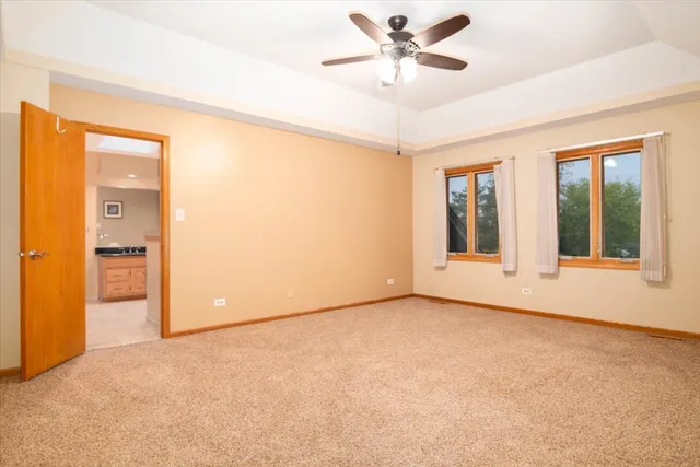 an empty room with a ceiling fan and a window