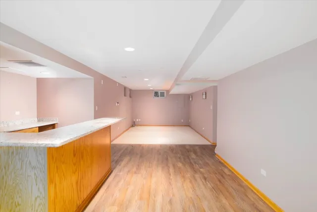 a view of a kitchen with a sink and a wooden floor