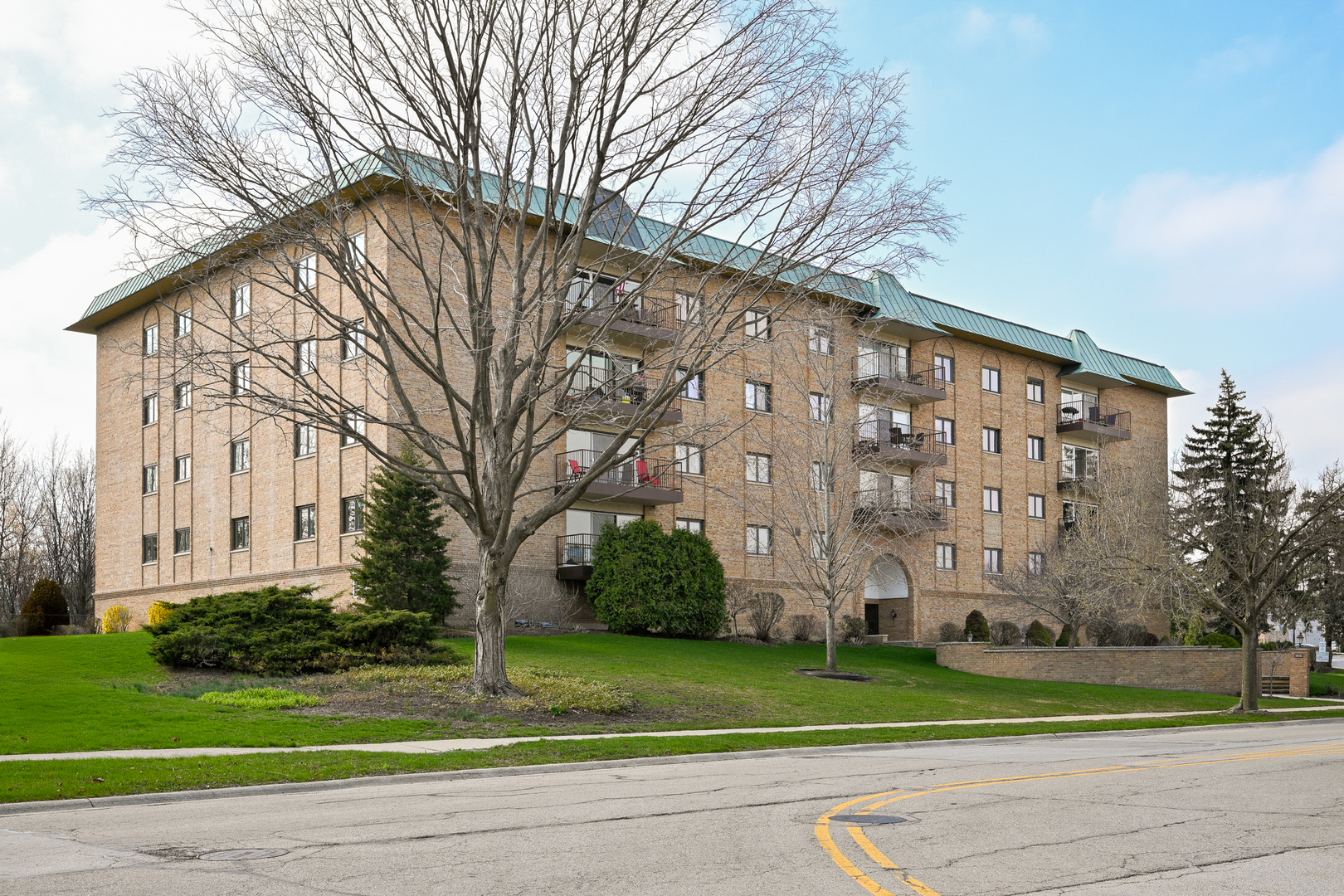 40 South Main Street, Unit 4A Glen Ellyn, IL 60137 - Photo 18 of 25 a brick building with trees in front of it