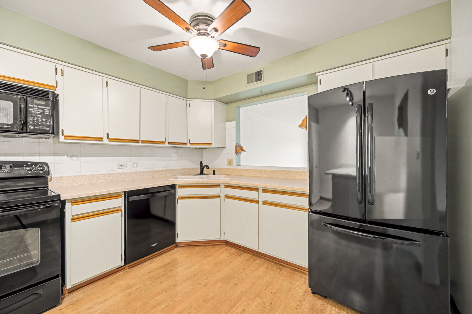 40 South Main Street, Unit 4A Glen Ellyn, IL 60137 - Photo 7 of 25 a kitchen with a refrigerator sink and cabinets