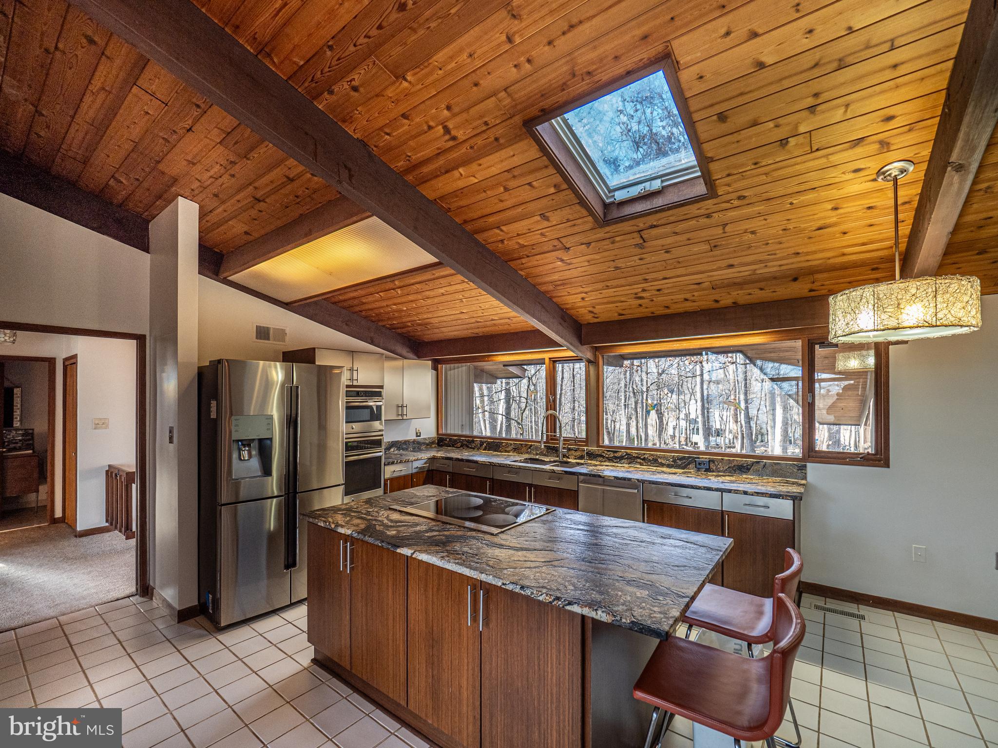 14805 Mockingbird Drive Darnestown, MD 20874 - Photo 11 of 35 a kitchen with stainless steel appliances granite countertop a sink and wooden cabinets