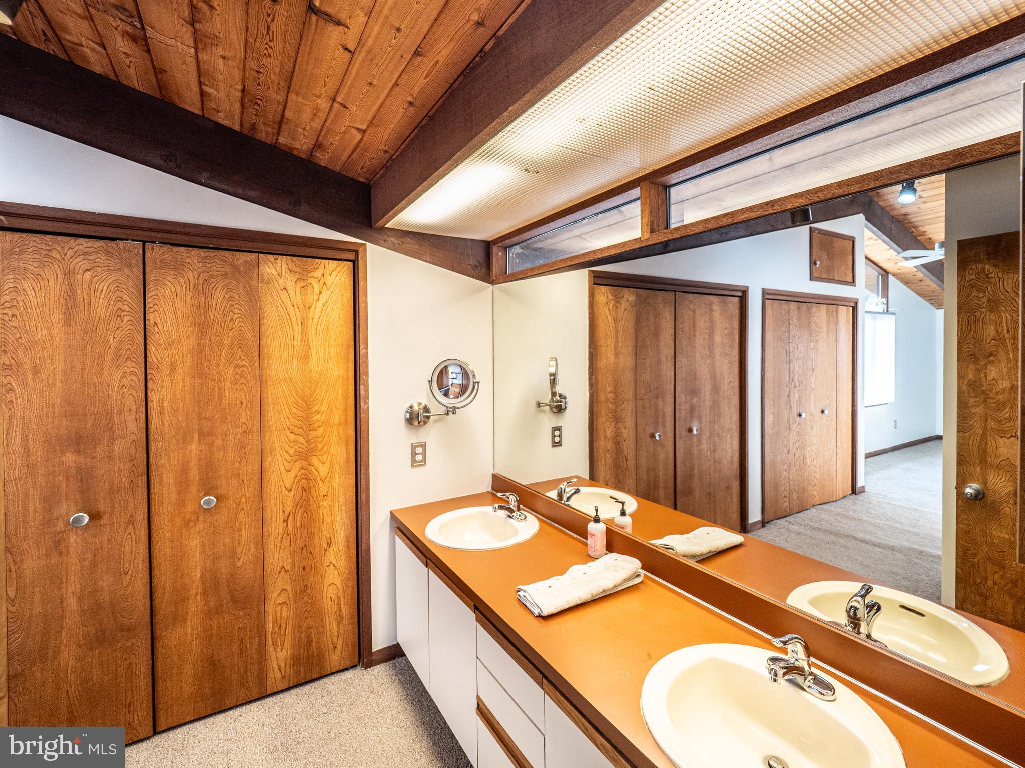 14805 Mockingbird Drive Darnestown, MD 20874 - Photo 19 of 35 a bathroom with a granite countertop sink and a mirror