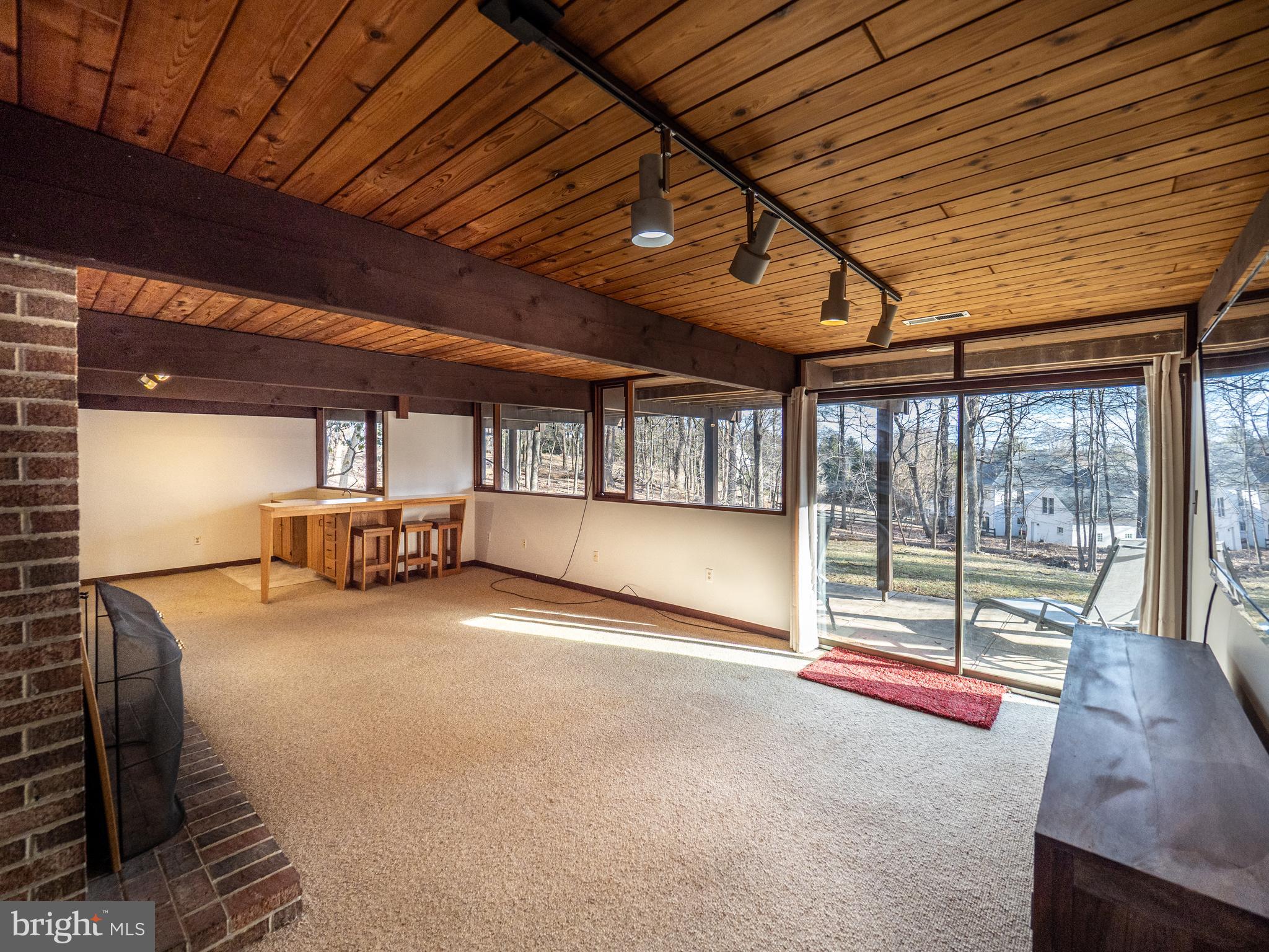 14805 Mockingbird Drive Darnestown, MD 20874 - Photo 23 of 35 a view of a livingroom with wooden floor and iron stairs