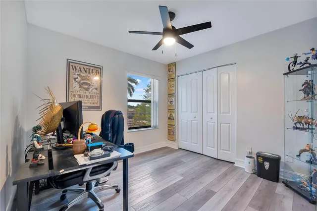 a view of a workspace with furniture and a window