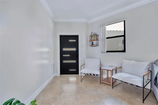 a living room with furniture and a painting on the wall