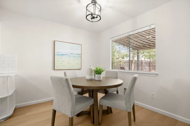 a kitchen with white cabinets and sink