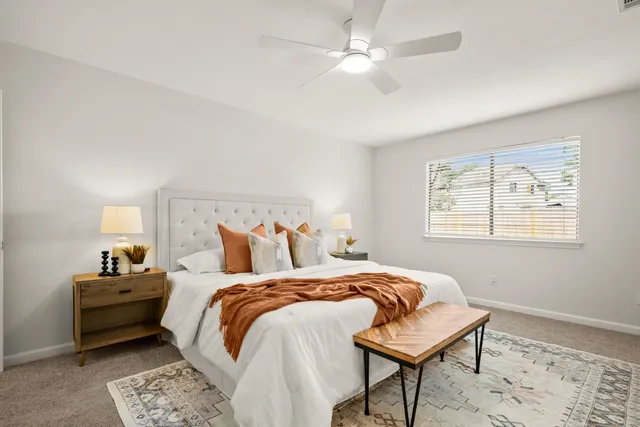 a bedroom with a bed and a potted plant