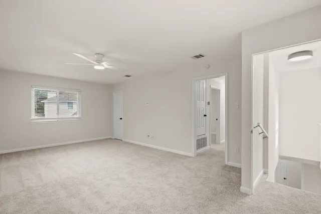 a bathroom with a granite countertop sink a mirror and a potted plant