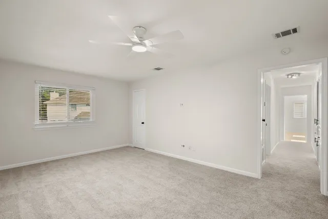 a bathroom with a granite countertop sink a toilet and a mirror