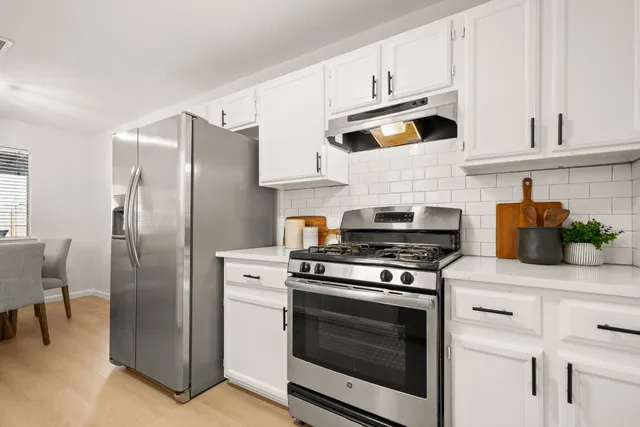 a living room with furniture a fireplace and a large window