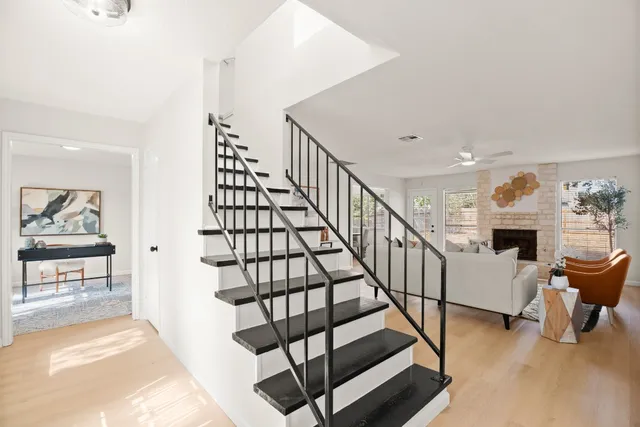 a kitchen with stainless steel appliances white cabinets and a stove top oven