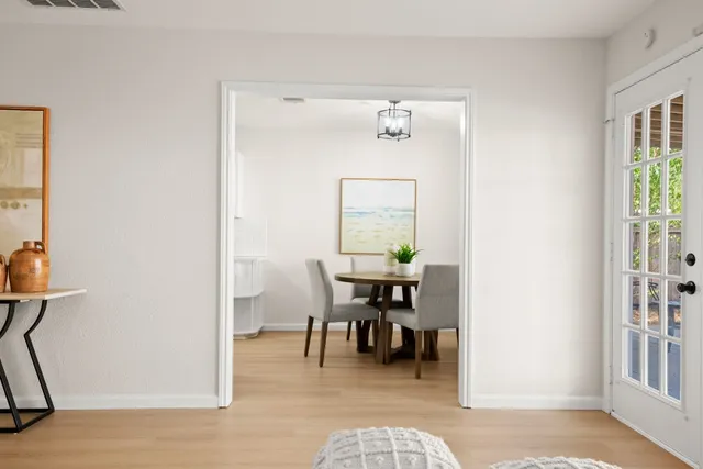 a living room with furniture and wooden floor