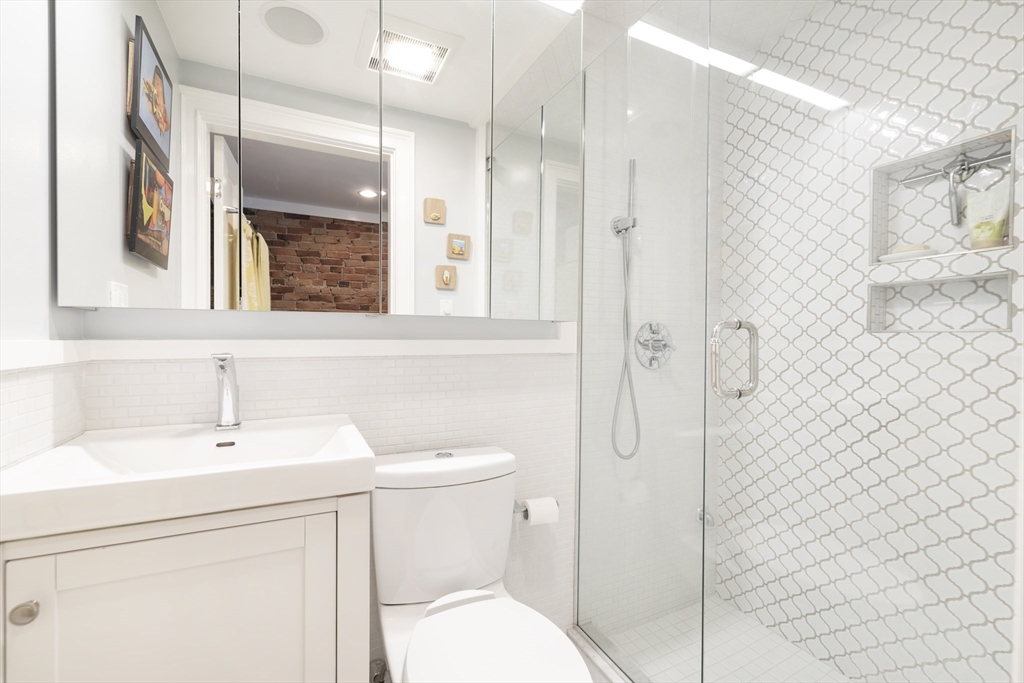 290 Shawmut Avenue, Unit 4 Boston, MA 02118 - Photo 11 of 28 a bathroom with a sink a toilet and shower