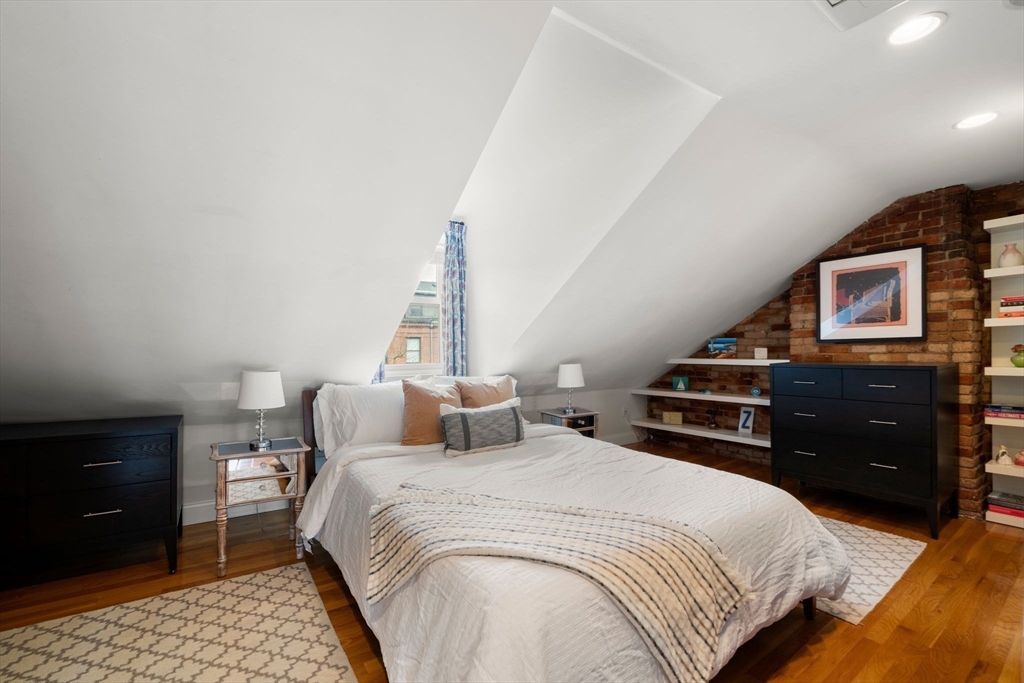 290 Shawmut Avenue, Unit 4 Boston, MA 02118 - Photo 12 of 28 a bedroom with a bed and wooden floor