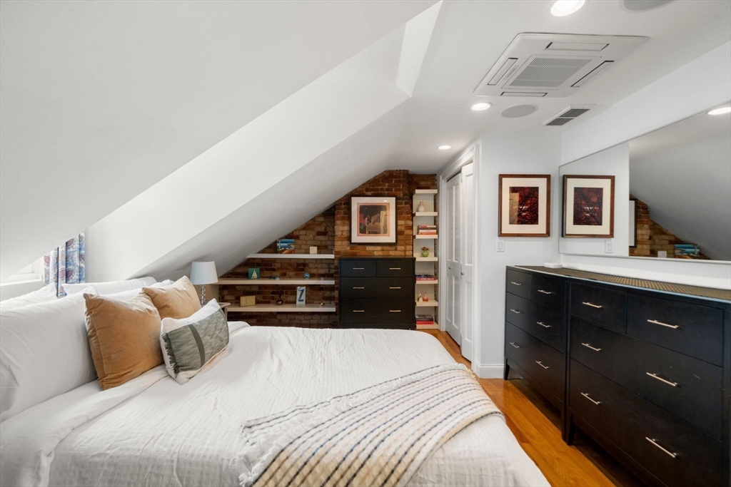 290 Shawmut Avenue, Unit 4 Boston, MA 02118 - Photo 13 of 28 a bedroom with a bed and a flat tv screen on dresser