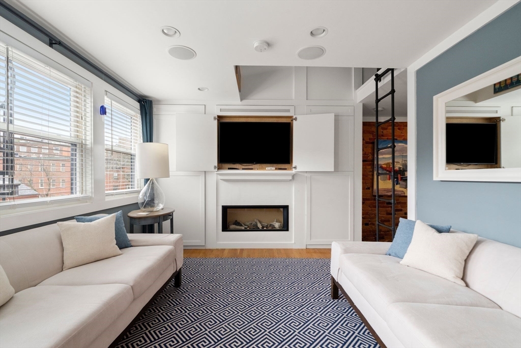 290 Shawmut Avenue, Unit 4 Boston, MA 02118 - Photo 2 of 28 a living room with furniture a fireplace and a flat screen tv