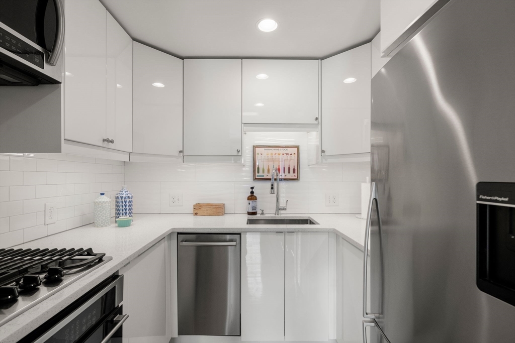 290 Shawmut Avenue, Unit 4 Boston, MA 02118 - Photo 8 of 28 a kitchen with stainless steel appliances a sink stove and refrigerator
