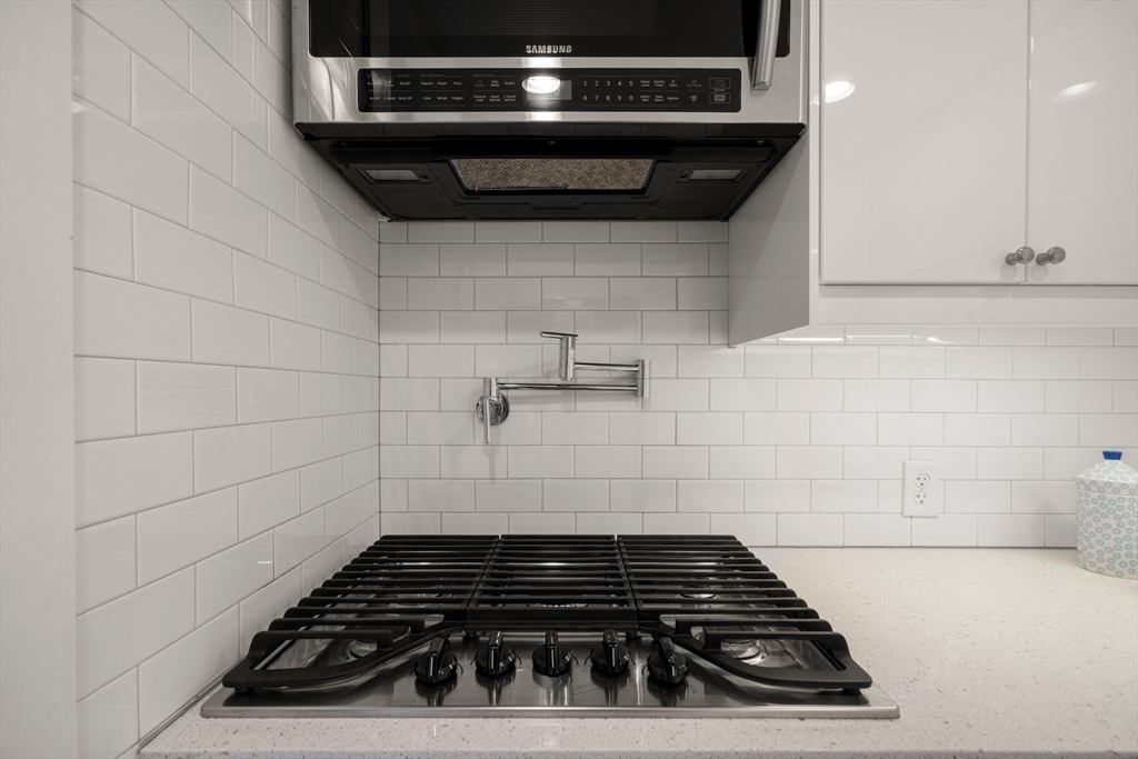 290 Shawmut Avenue, Unit 4 Boston, MA 02118 - Photo 9 of 28 a close view of a stove a microwave and cabinets