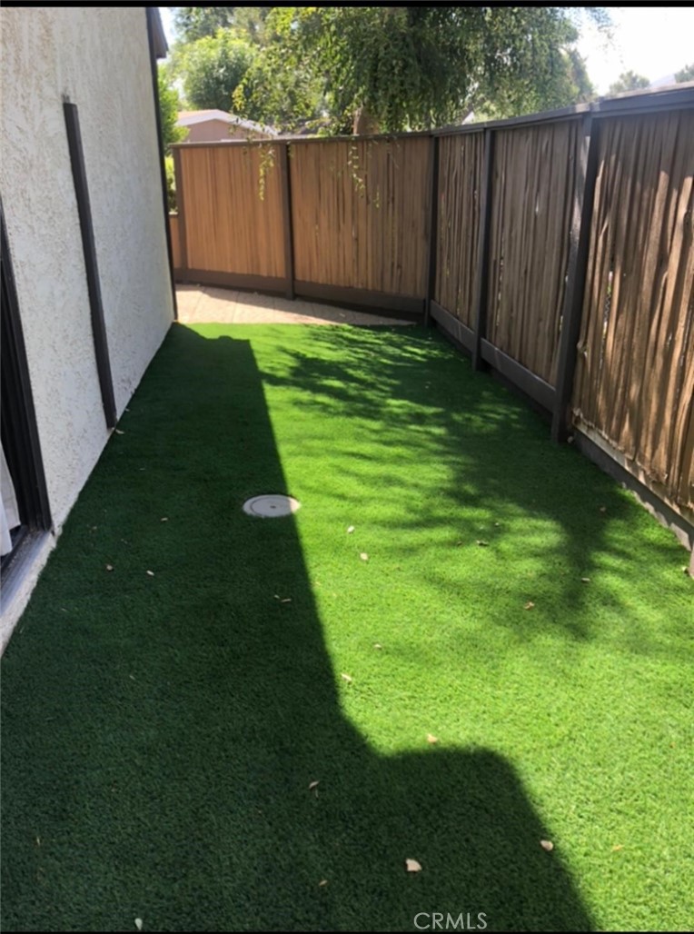 18223 Soledad Canyon Road, Unit 45 Canyon Country, CA 91387 - Photo 12 of 24 a view of a backyard with wooden fence