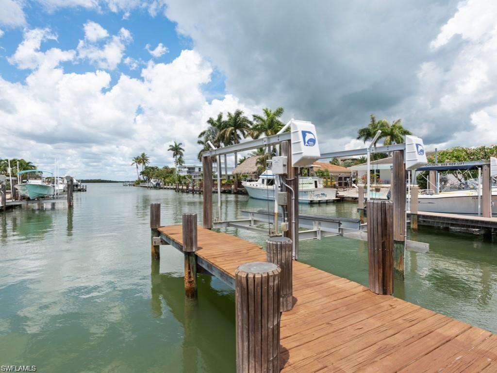 945 Sundrop Court Marco Island, FL 34145 - Photo 31 of 31 Dock featuring boat lift and a water view