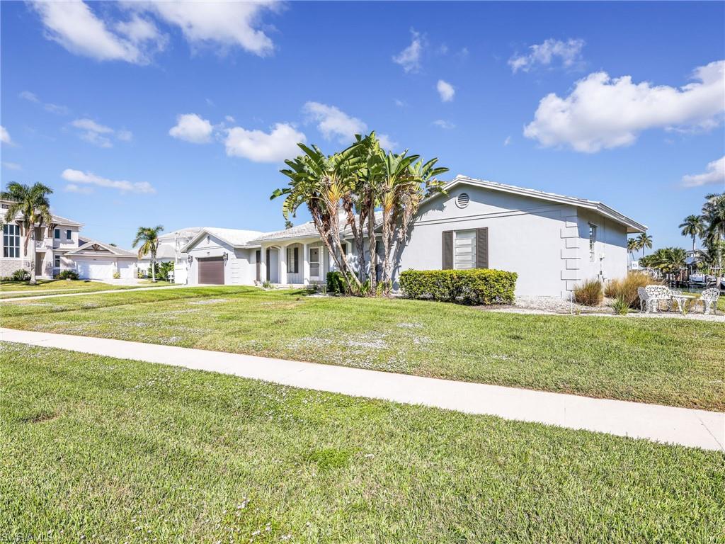945 Sundrop Court Marco Island, FL 34145 - Photo 5 of 31 a house view with a garden space