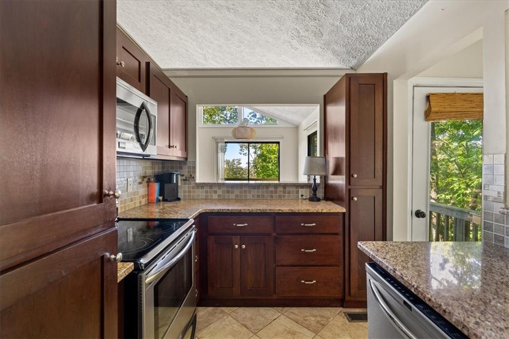 157 Sunrise Terrace Jasper, GA 30143 - Photo 12 of 54 a kitchen with granite countertop a sink stove and cabinets
