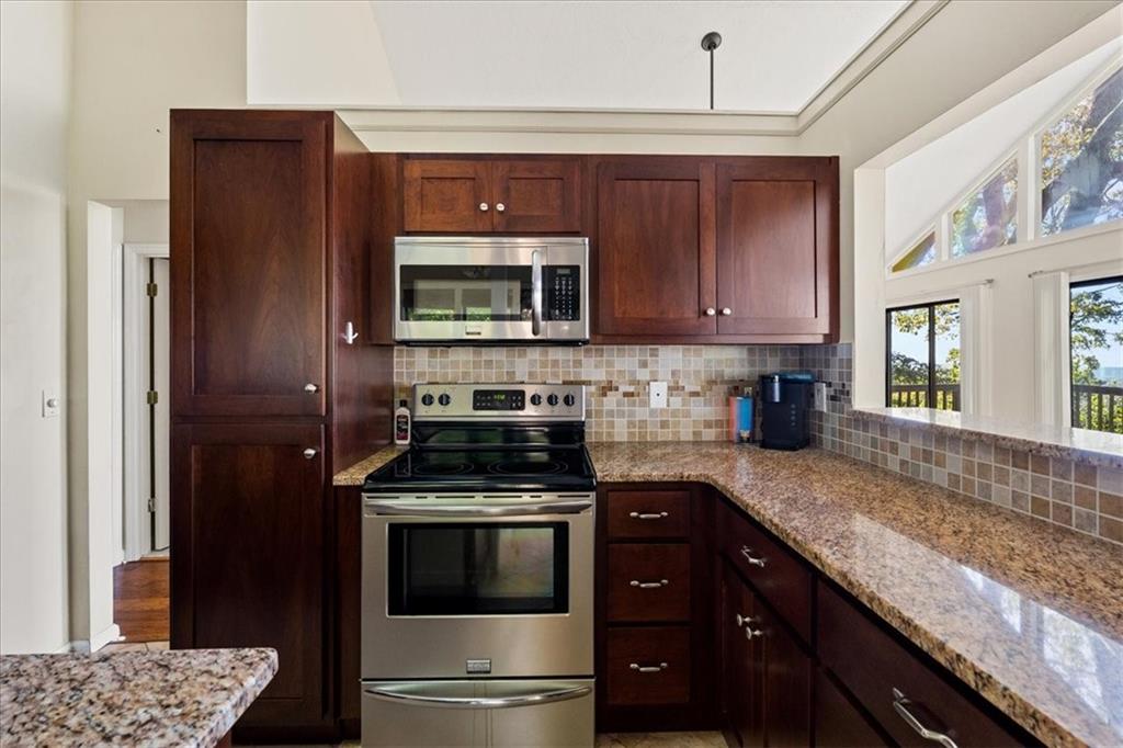 157 Sunrise Terrace Jasper, GA 30143 - Photo 13 of 54 a kitchen with granite countertop wooden cabinets and stainless steel appliances
