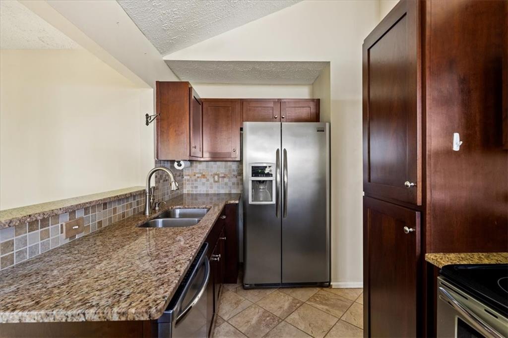 157 Sunrise Terrace Jasper, GA 30143 - Photo 14 of 54 a kitchen with granite countertop a refrigerator and a sink