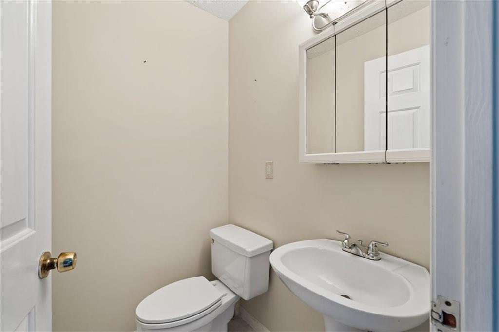 157 Sunrise Terrace Jasper, GA 30143 - Photo 18 of 54 a white toilet sitting next to a bathroom sink