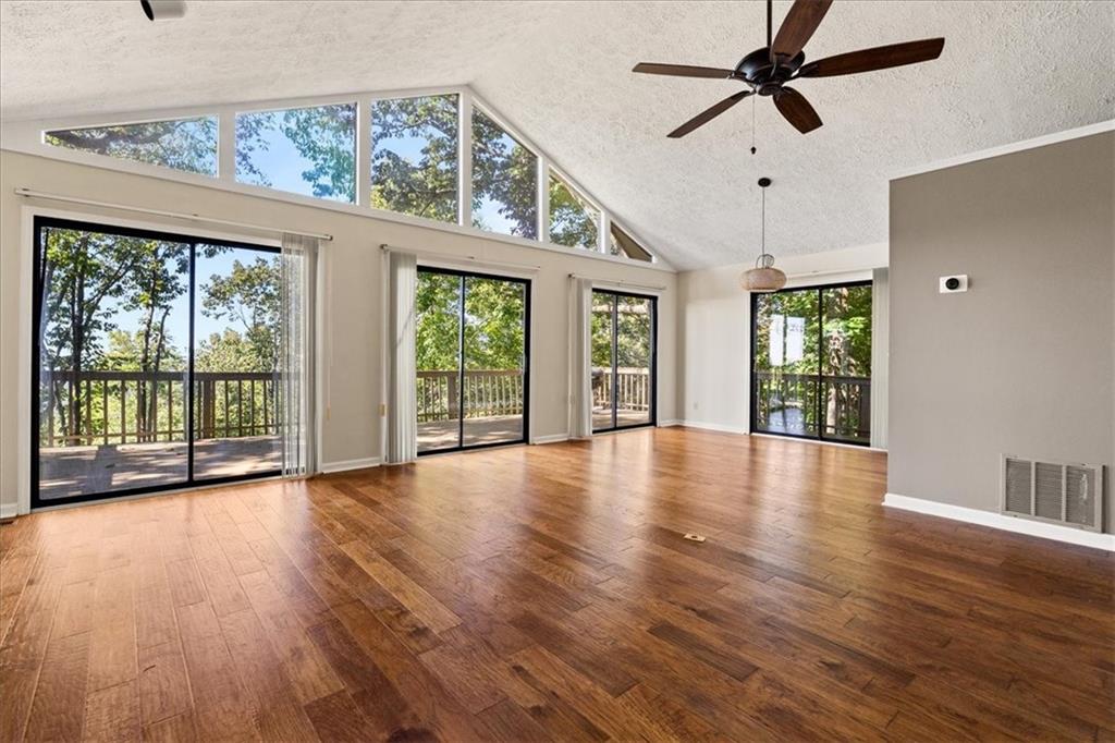 157 Sunrise Terrace Jasper, GA 30143 - Photo 4 of 54 a view of an empty room with wooden floor and a window