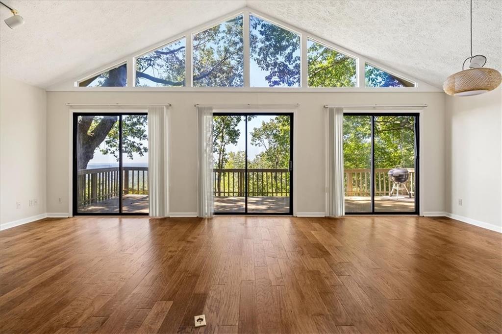 157 Sunrise Terrace Jasper, GA 30143 - Photo 9 of 54 a view of an empty room with wooden floor and a window