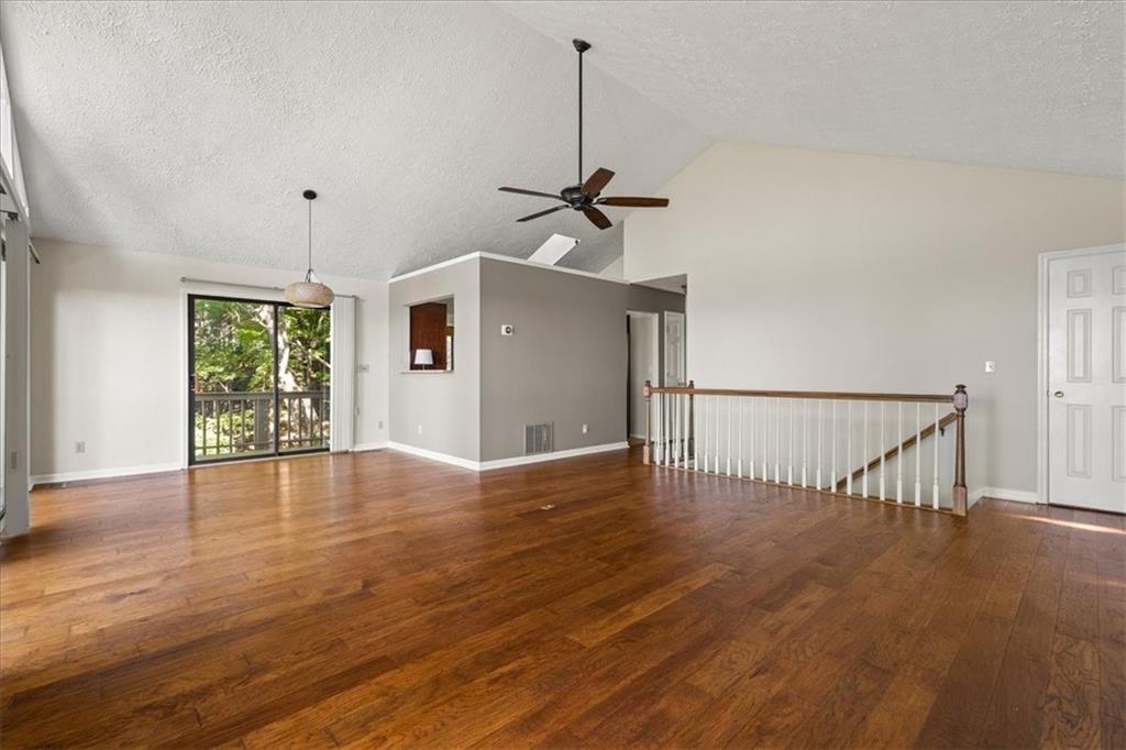 157 Sunrise Terrace Jasper, GA 30143 - Photo 10 of 54 a view of an empty room with wooden floor ceiling fan and a window