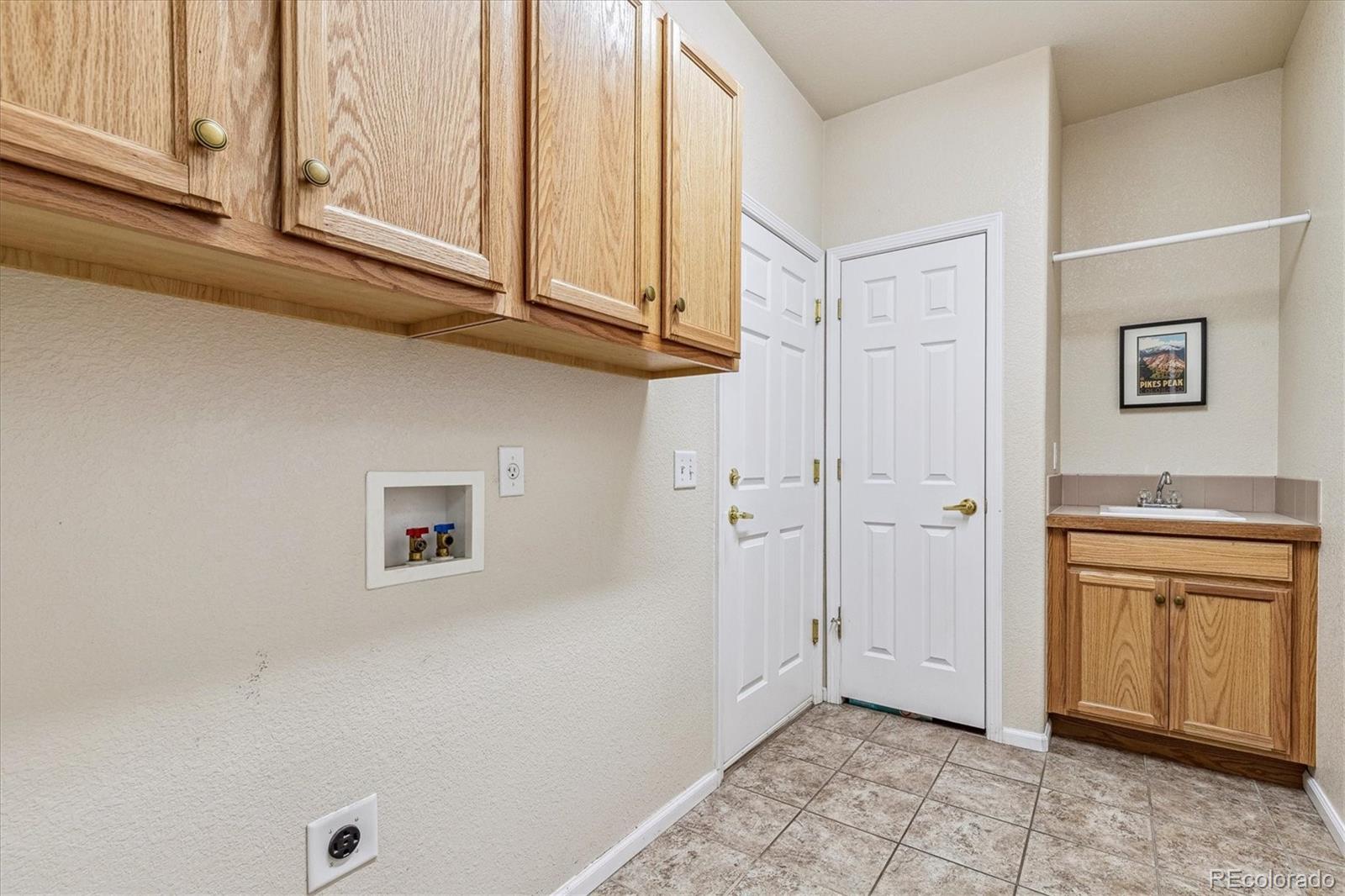 6596 South Reed Way, Unit B Littleton, CO 80123 - Photo 17 of 22 a view of cabinets and wooden floor
