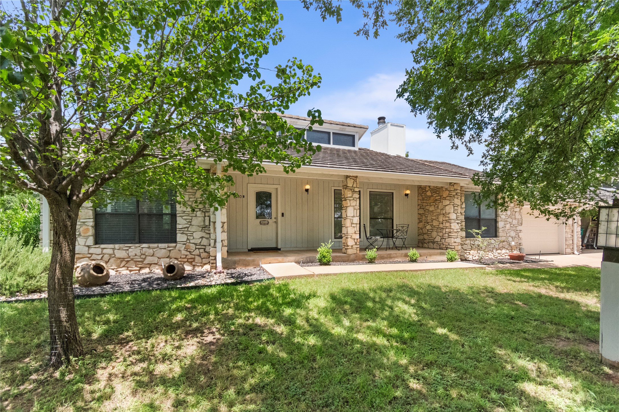 210 Teeoff, Unit B Horseshoe Bay, TX 78657 - Photo 3 of 38 Stone and siding create an inviting facade for this home with a welcoming front porch.