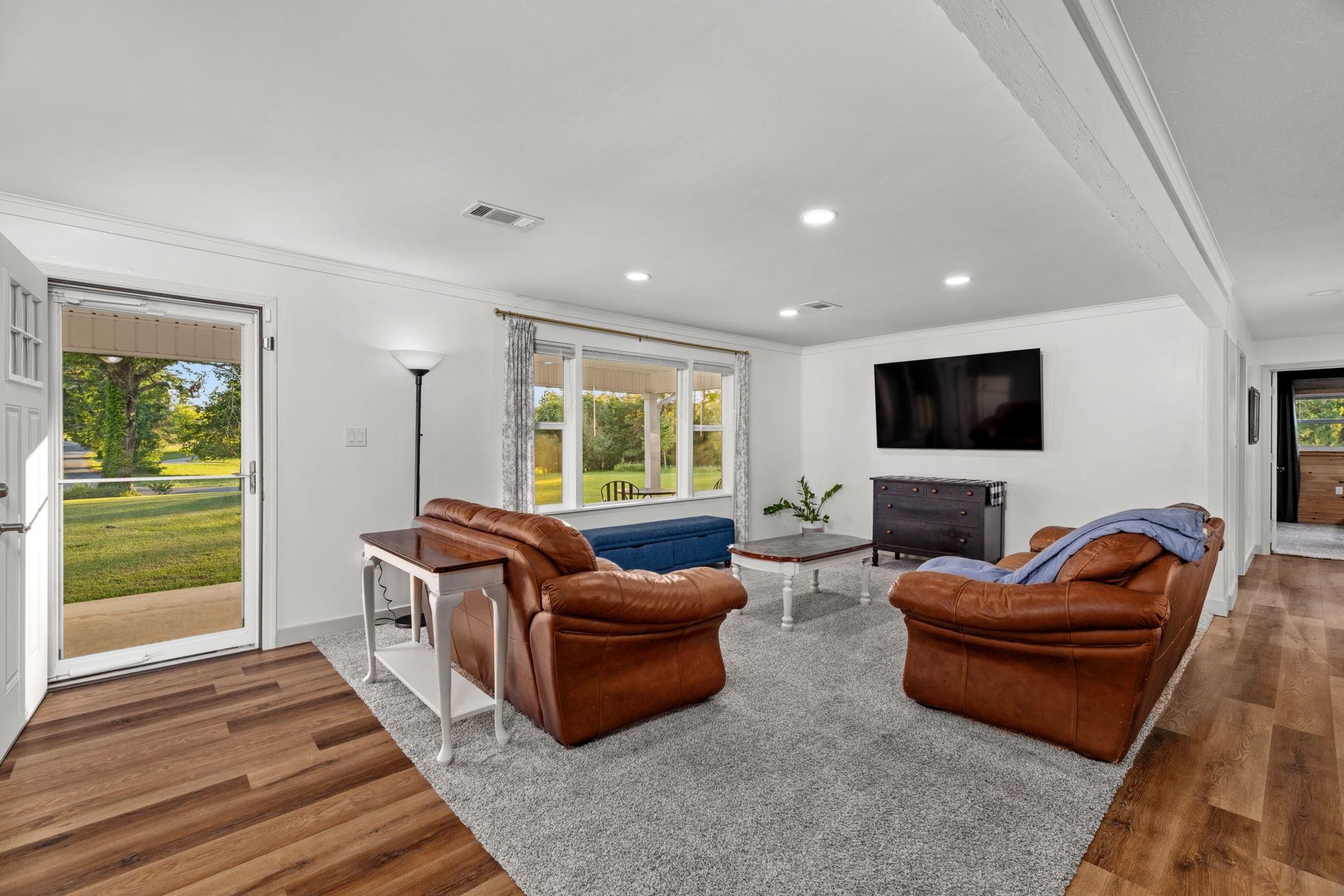 66 County Road 511 Corinth, MS 38834 - Photo 5 of 40 Living room featuring wood-finish flooring, recessed lighting, a large window providing natural light, and a white interior color palette
