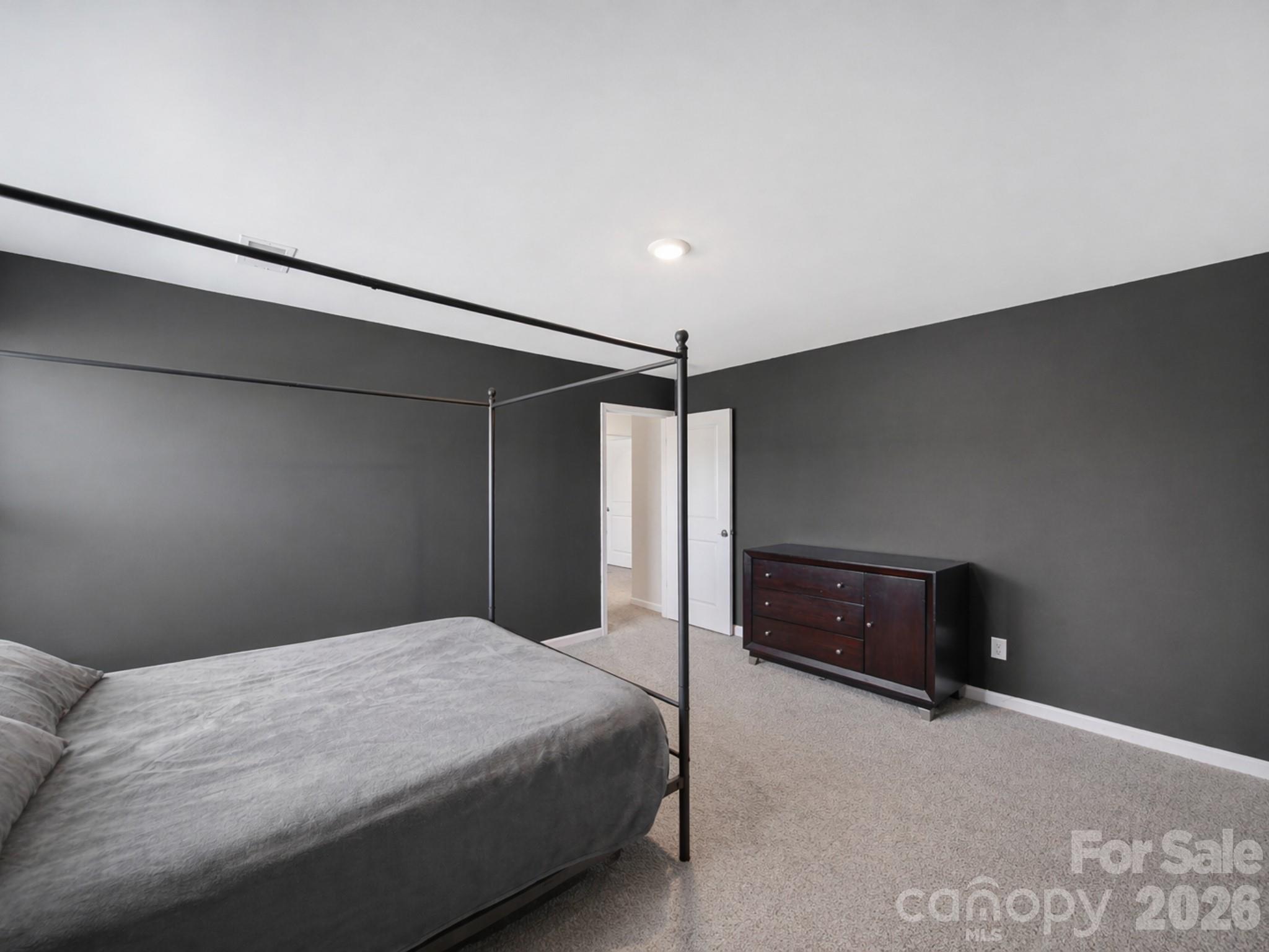 107 Spring Hall Court Troutman, NC 28166 - Photo 20 of 28 a bedroom with a bed and a ceiling fan